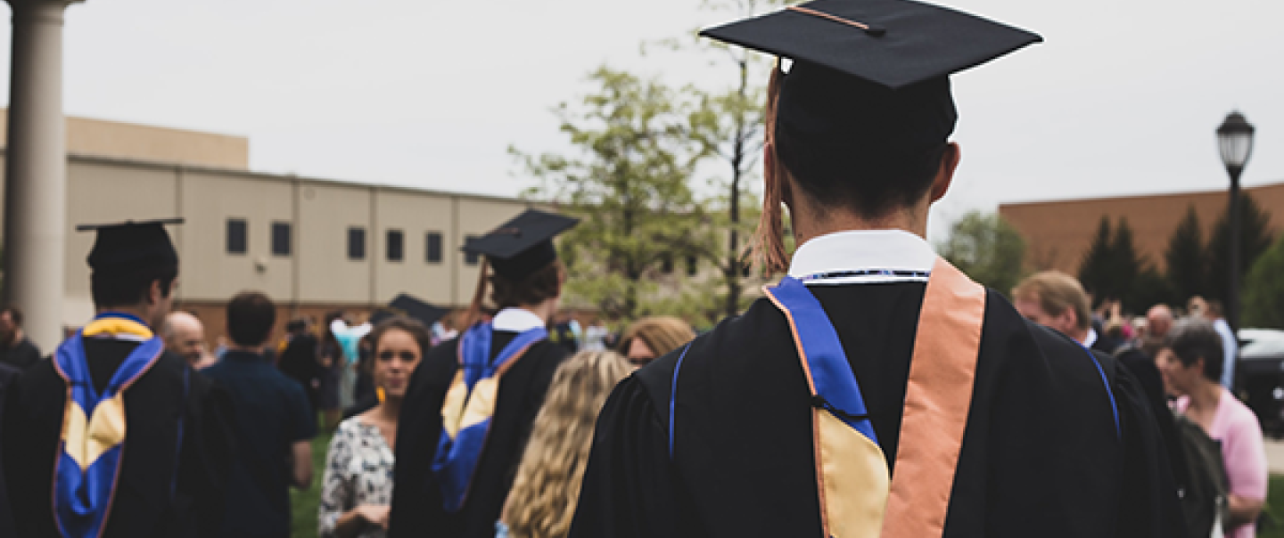 Photo of school graduates with robes at graduation