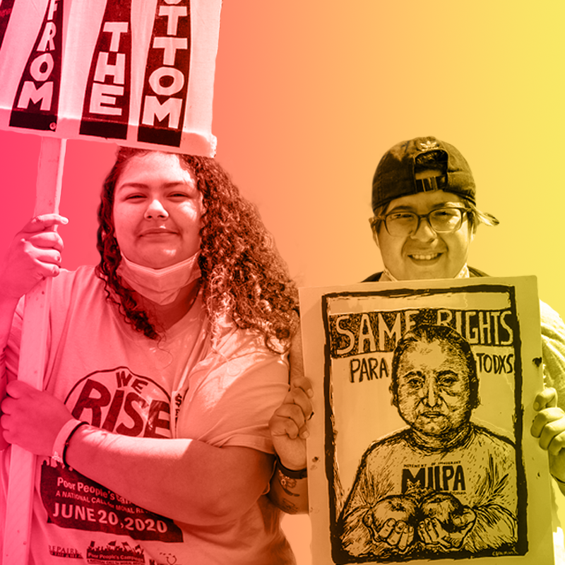 Two people hold signs at the Poor Peoples Campaign March on Washington.