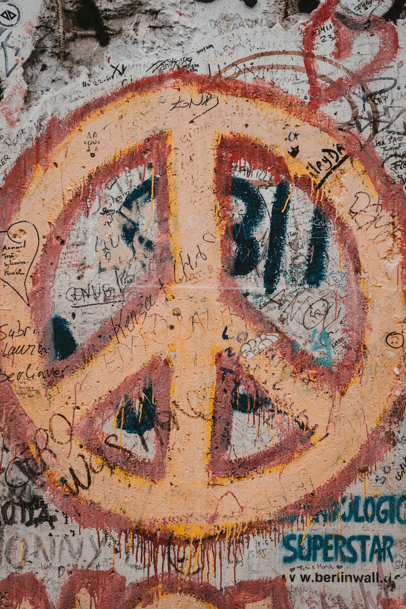Peace sign spray painted on section of the Berlin Wall.